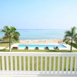 A beautiful beachfront pool area with palm trees