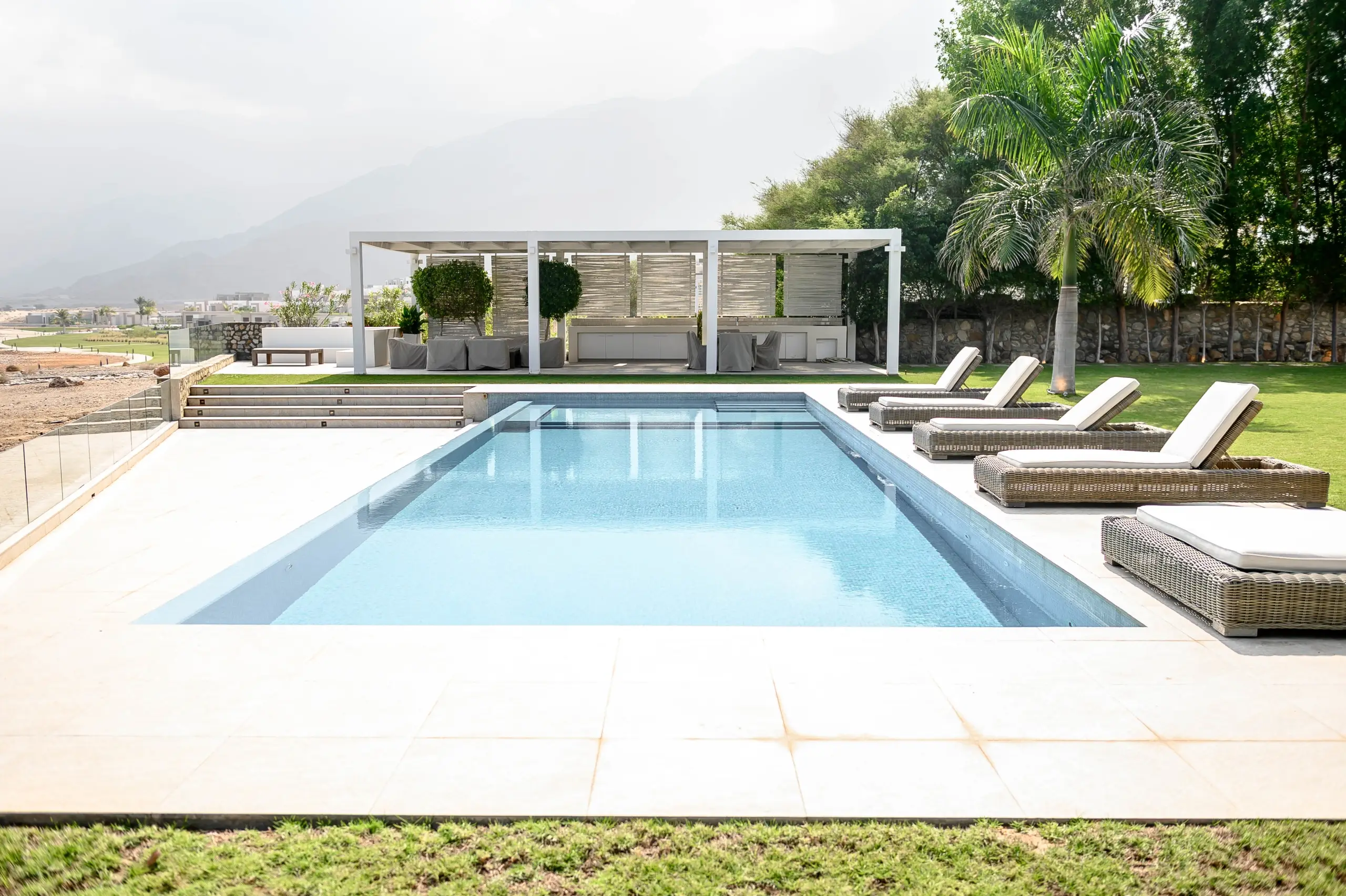 Outdoor pool area with mountain view