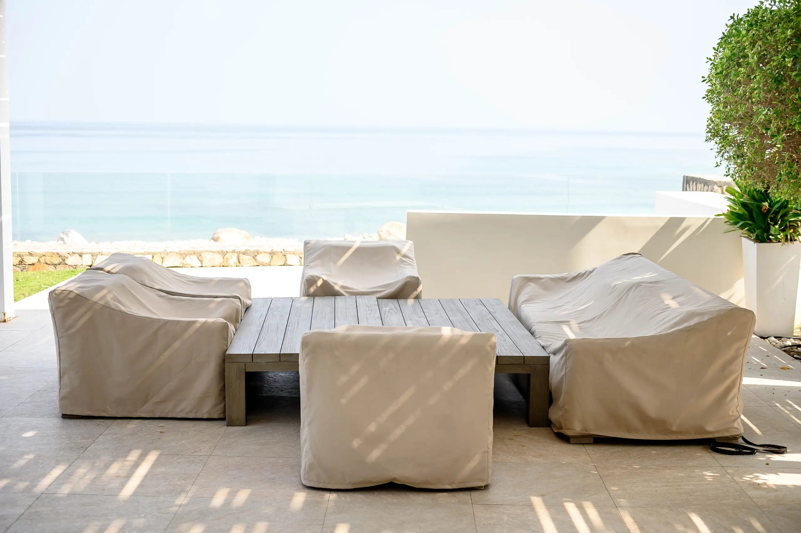 Patio with covered outdoor furniture, sea view