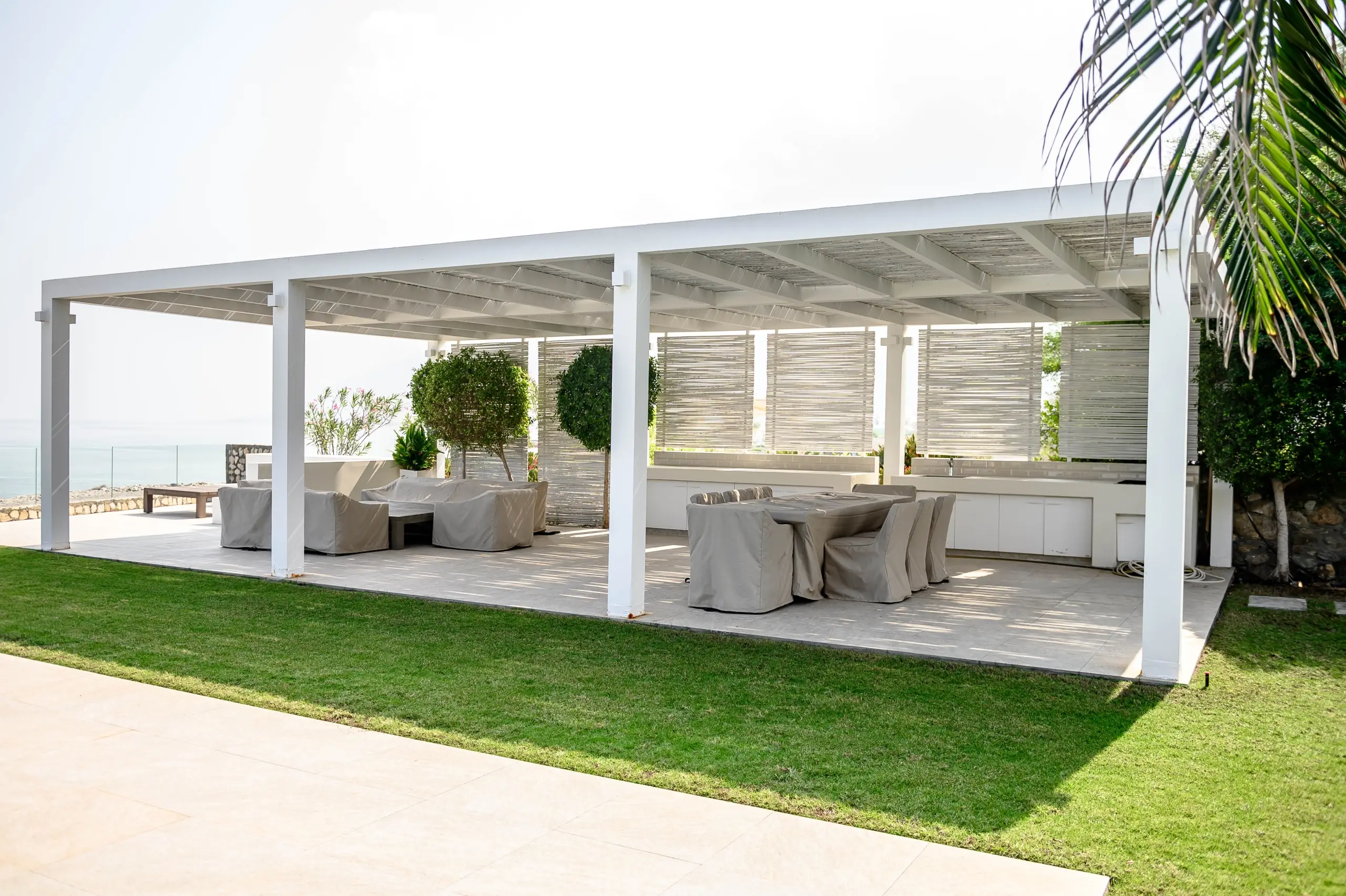 Pergola covering outdoor dining, lounge, sea