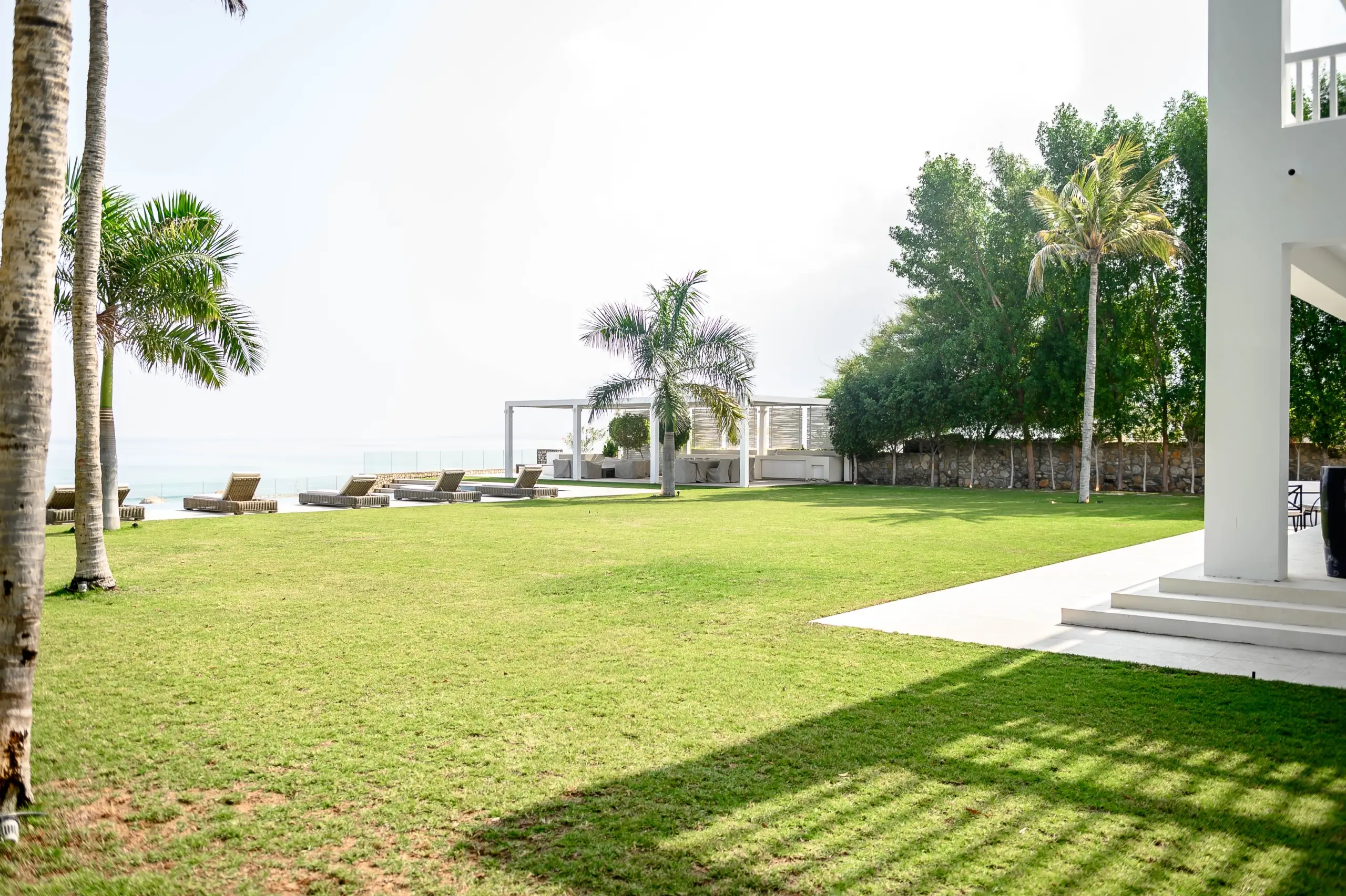 A vast green lawn by the sea
