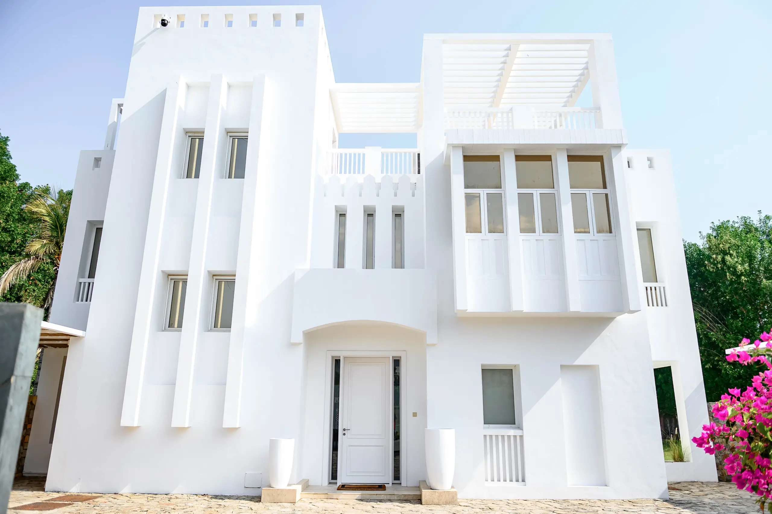 A bright white multi-story house