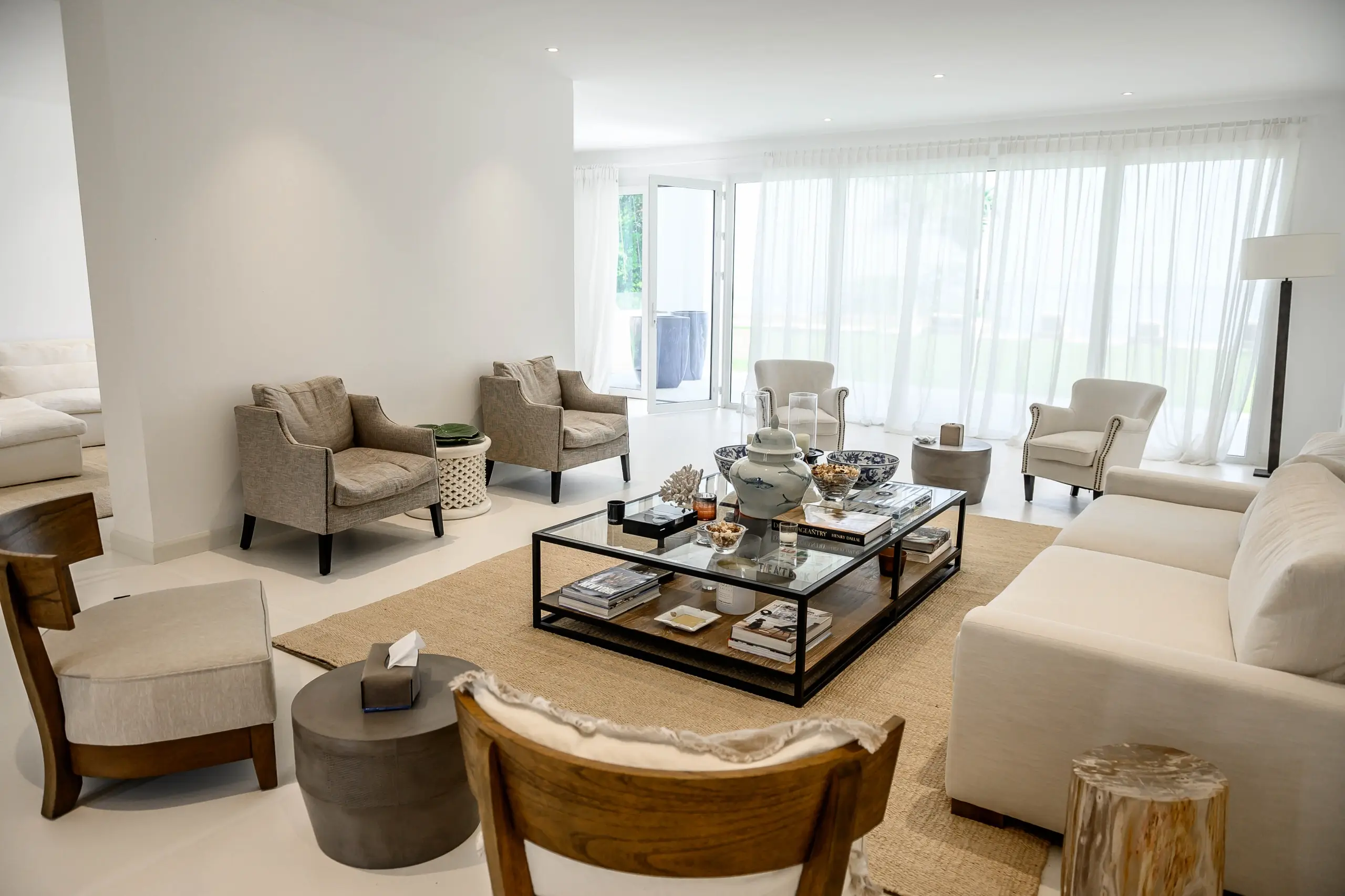 A brightly lit living room with a large sofa.